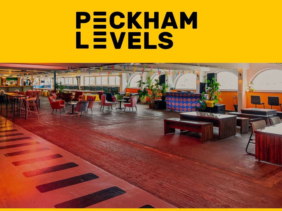 Peckham Levels Unusual-London-budget-wedding-venue A screenshot with yellow at the top and PECKHAM LEVELS in capital block black letters. The image beneath is a large space with a wooden floor.