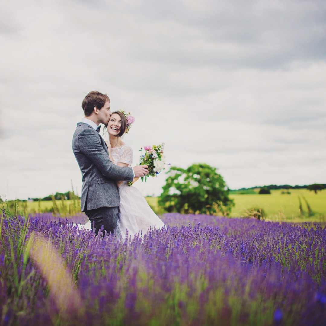 5 tips for newly engaged couples 5 tips for newly engaged couples blog. A couple in a lavender field. They are Cis-het and white, she is wearing a crown and a white dress.