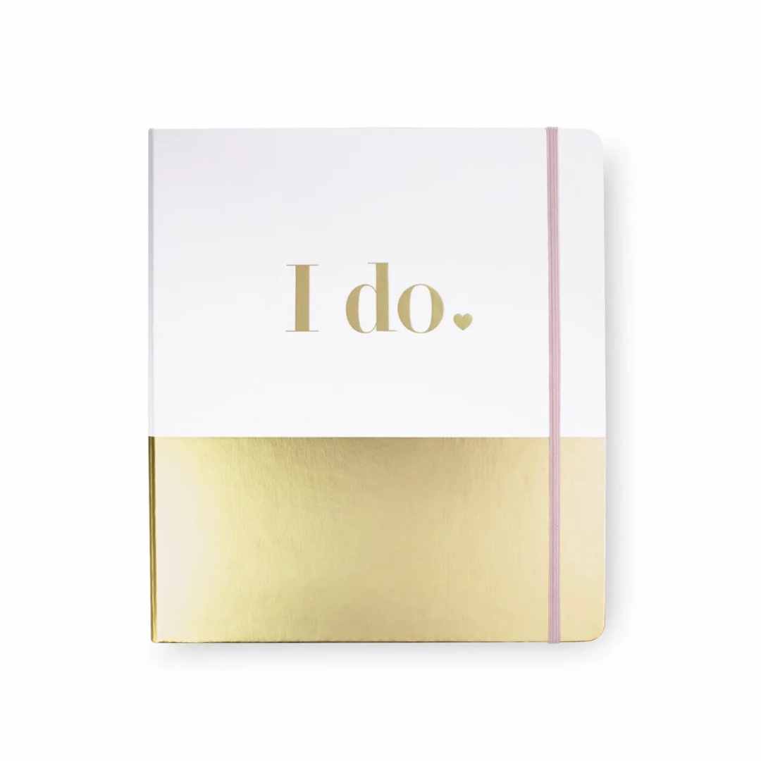 Wedding journal for newly engaged couples. A gold and white journal. It is simple with a gold band across the bottom and I do. in a nice typeface in gold lettering