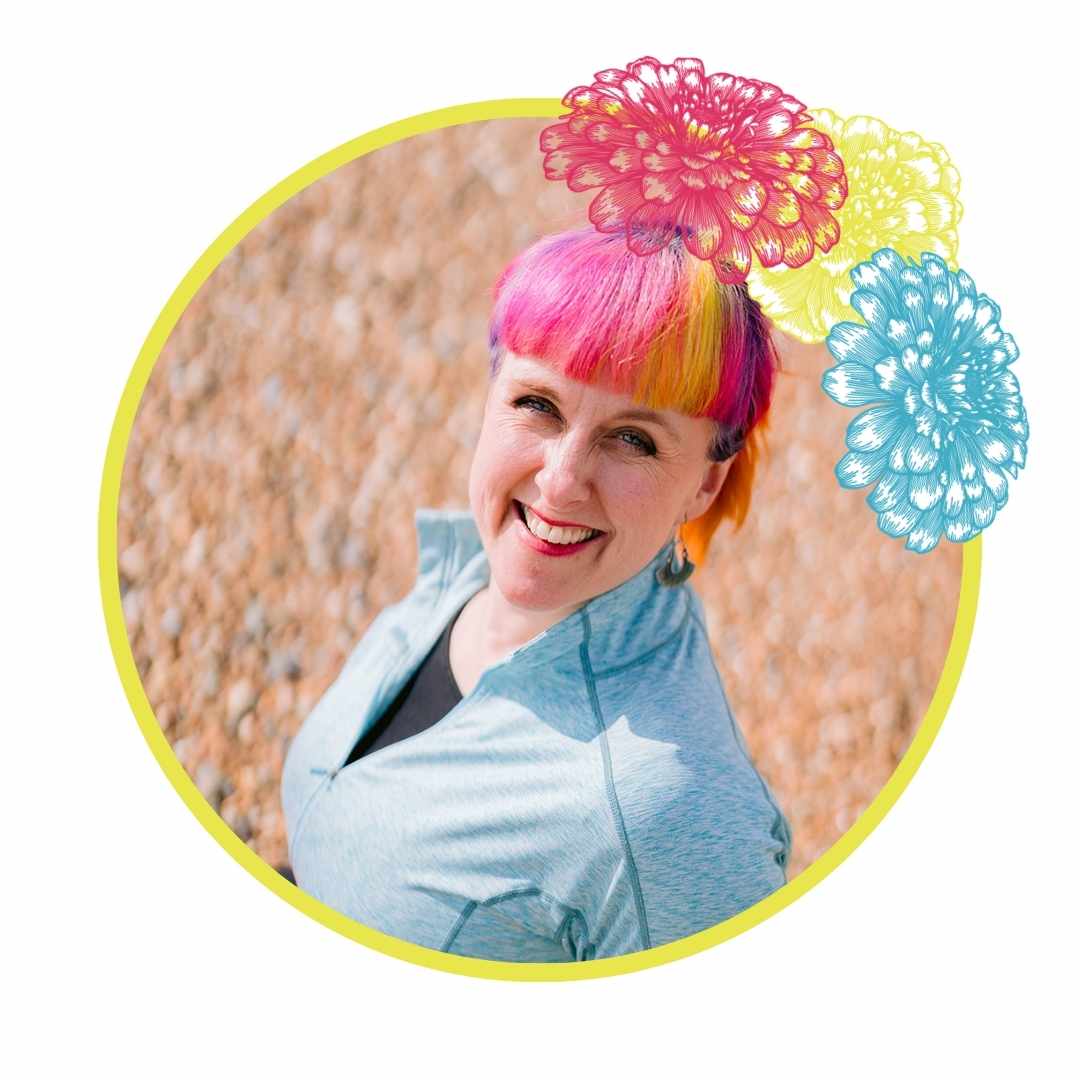 Wedding Celebrant for London wearing a blue top and has pink hair