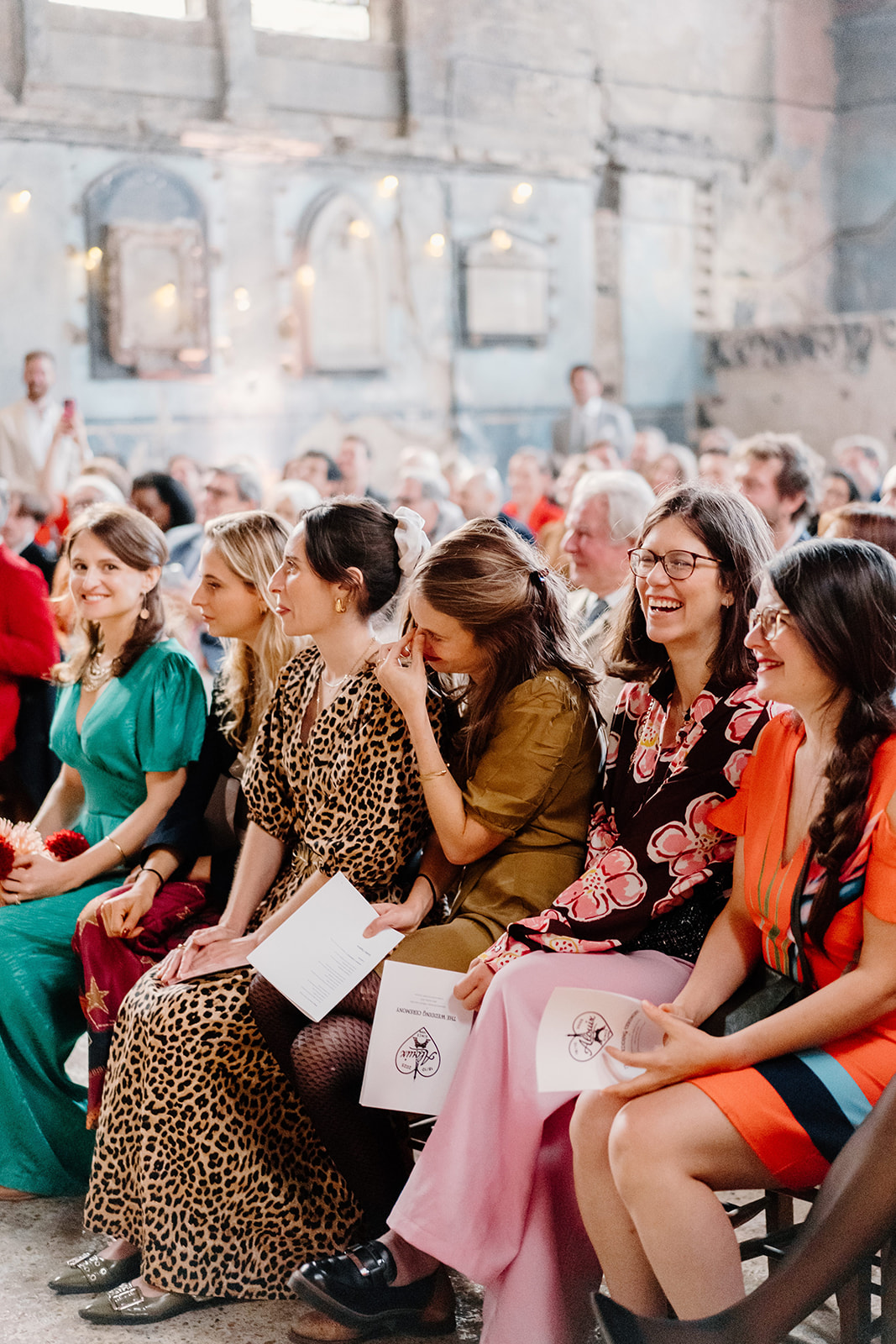 Asylum chapel guests crying A row of guests at a wedding one is crying with joy.
